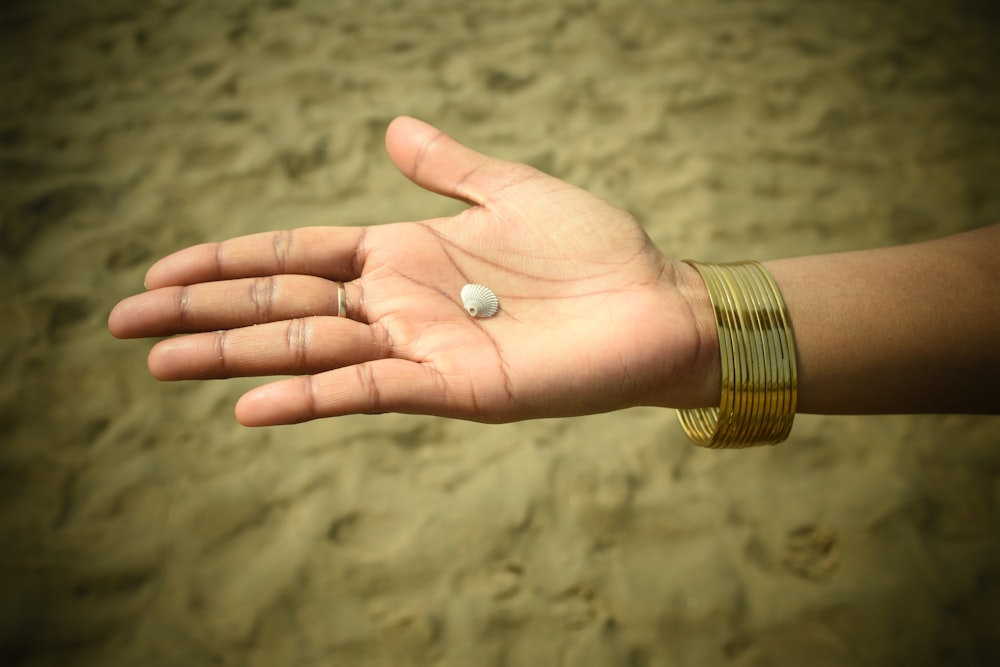 a person's hand with a ring on it