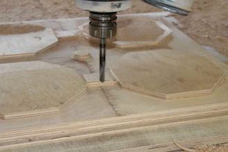 A clean workspace with a CNC machine carving a wooden project.