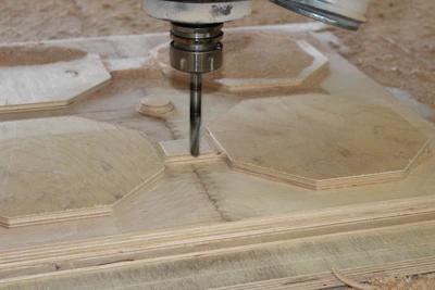 A clean workspace with a CNC machine carving a wooden project.