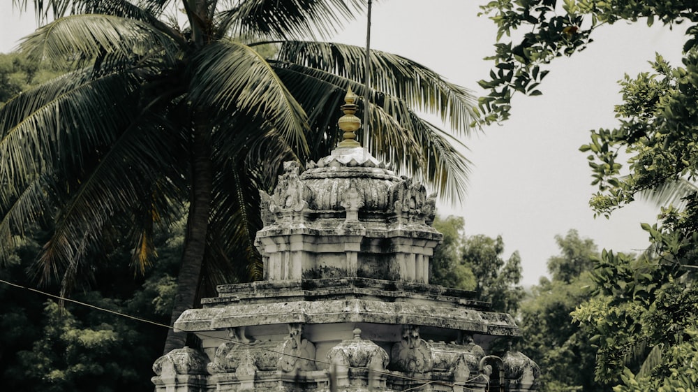 a large stone structure with trees around it