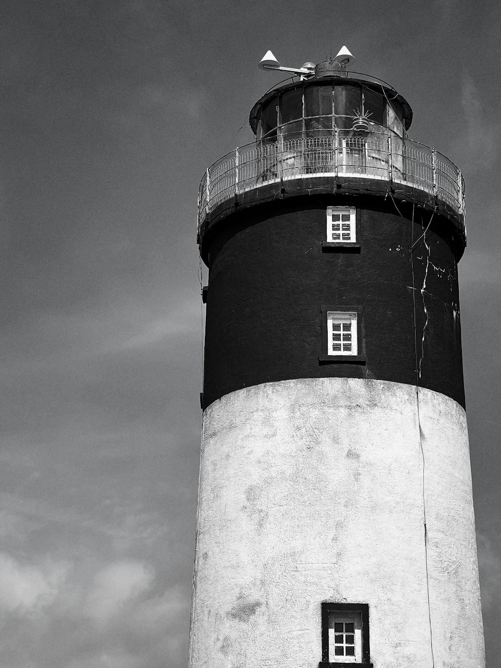 a black and white photo of a lighthouse