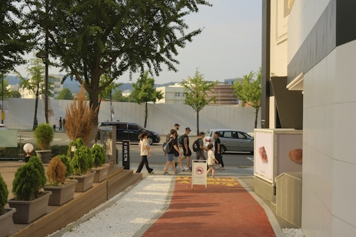 a group of people walking on a sidewalk