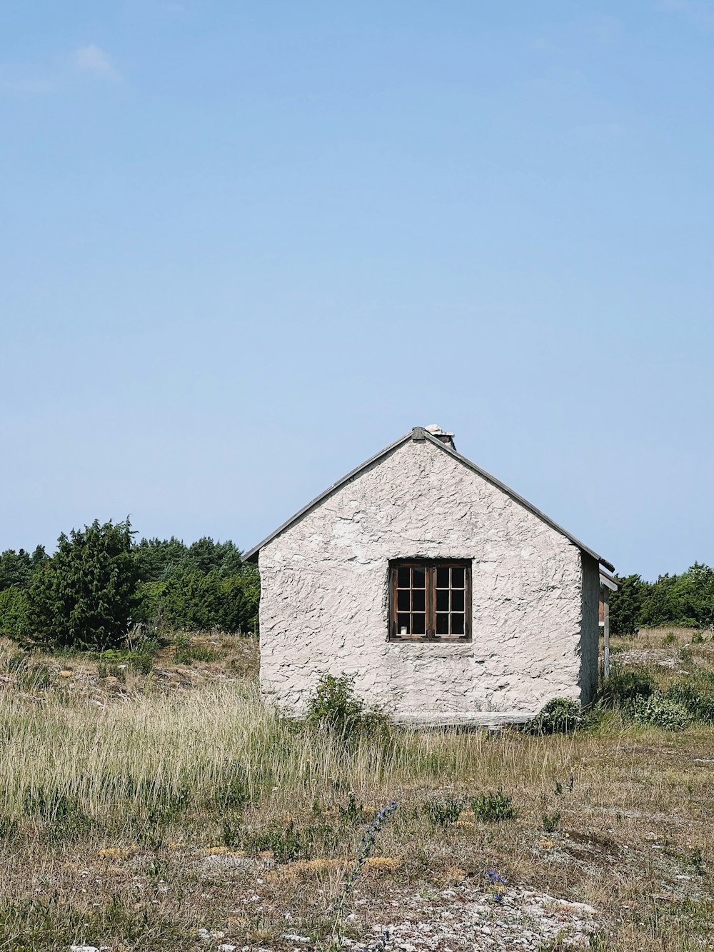 a white building in a grassy field