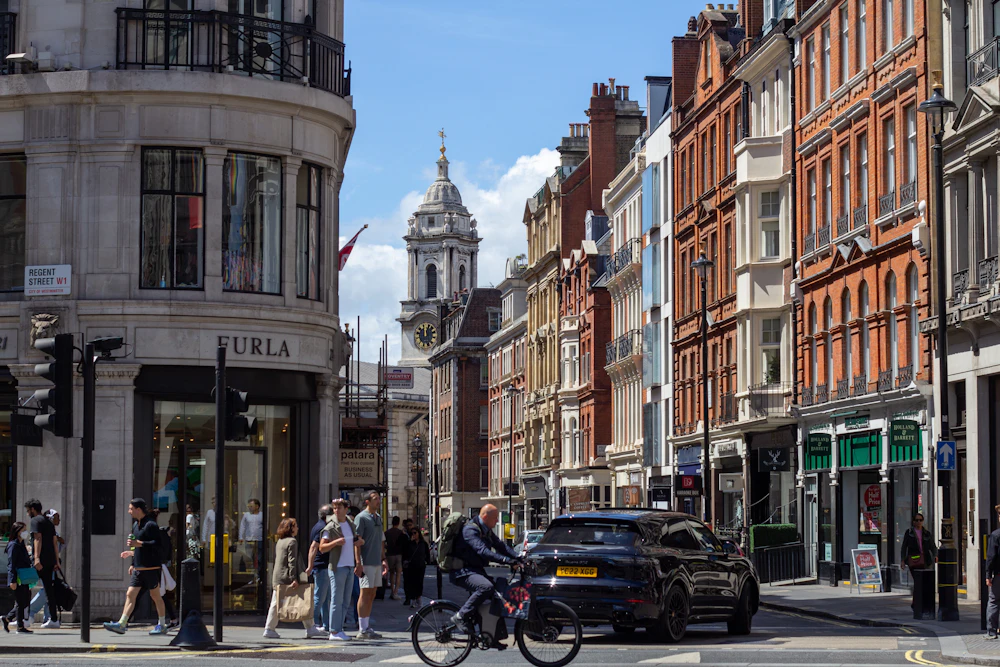 Regent Street curving through Mayfair beneath a blue sky