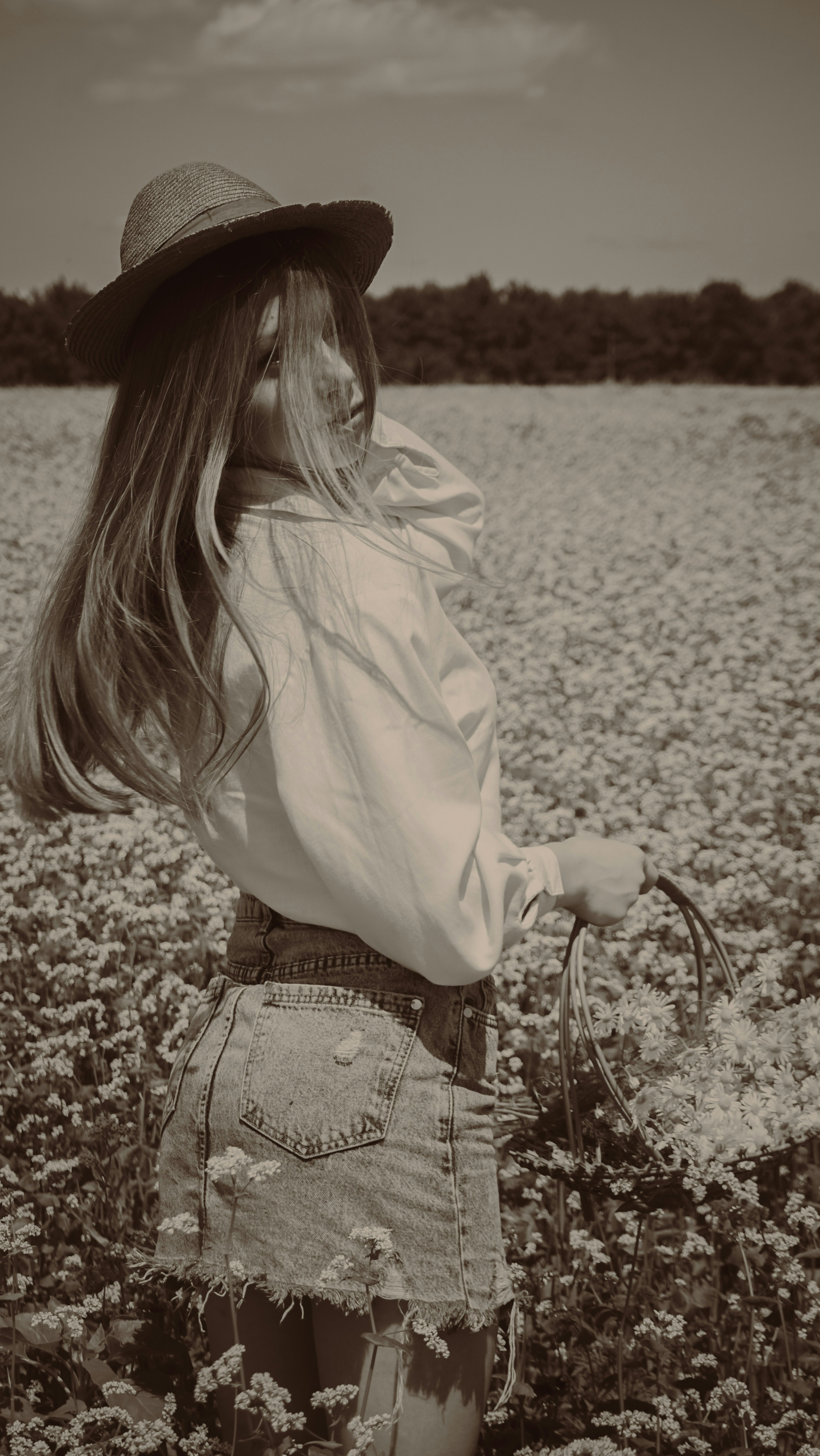 a person in a hat in a field of flowers