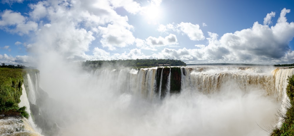 a large waterfall with a rainbow