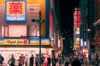 a group of people walking on a city street