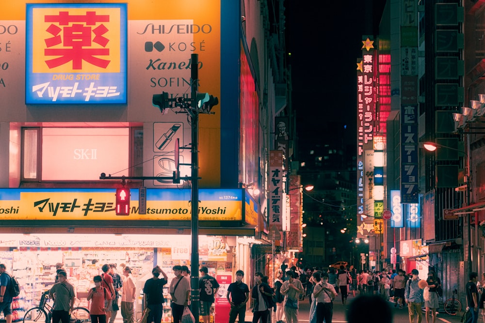 a group of people walking on a city street