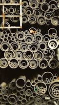 Close-up of steel pipes stacked neatly in a warehouse, ready for shipment.