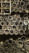 Rows of steel pipes neatly arranged in an industrial storage area.