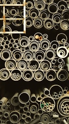 A collection of multi-material pipes displayed on a workshop table.