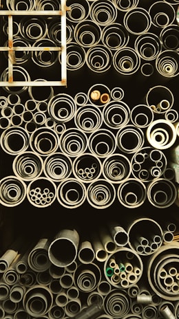 Various sizes of steel pipes stacked for industrial use.