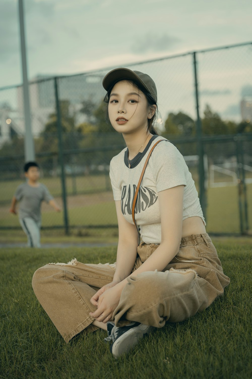 a woman sitting on grass