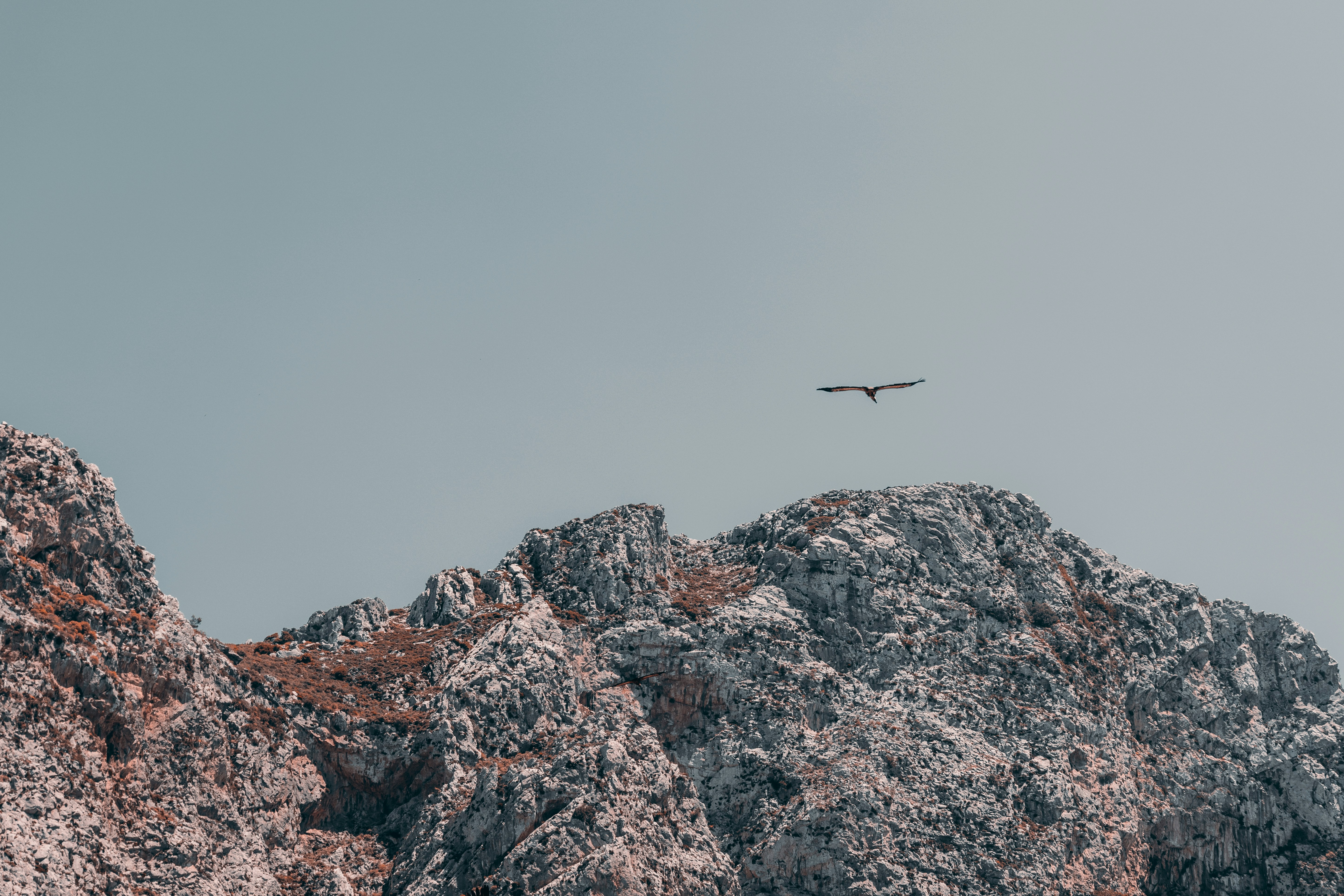 a plane flying over a mountain