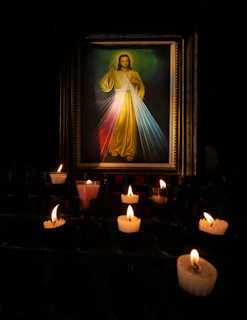 a lit candle in a dark room