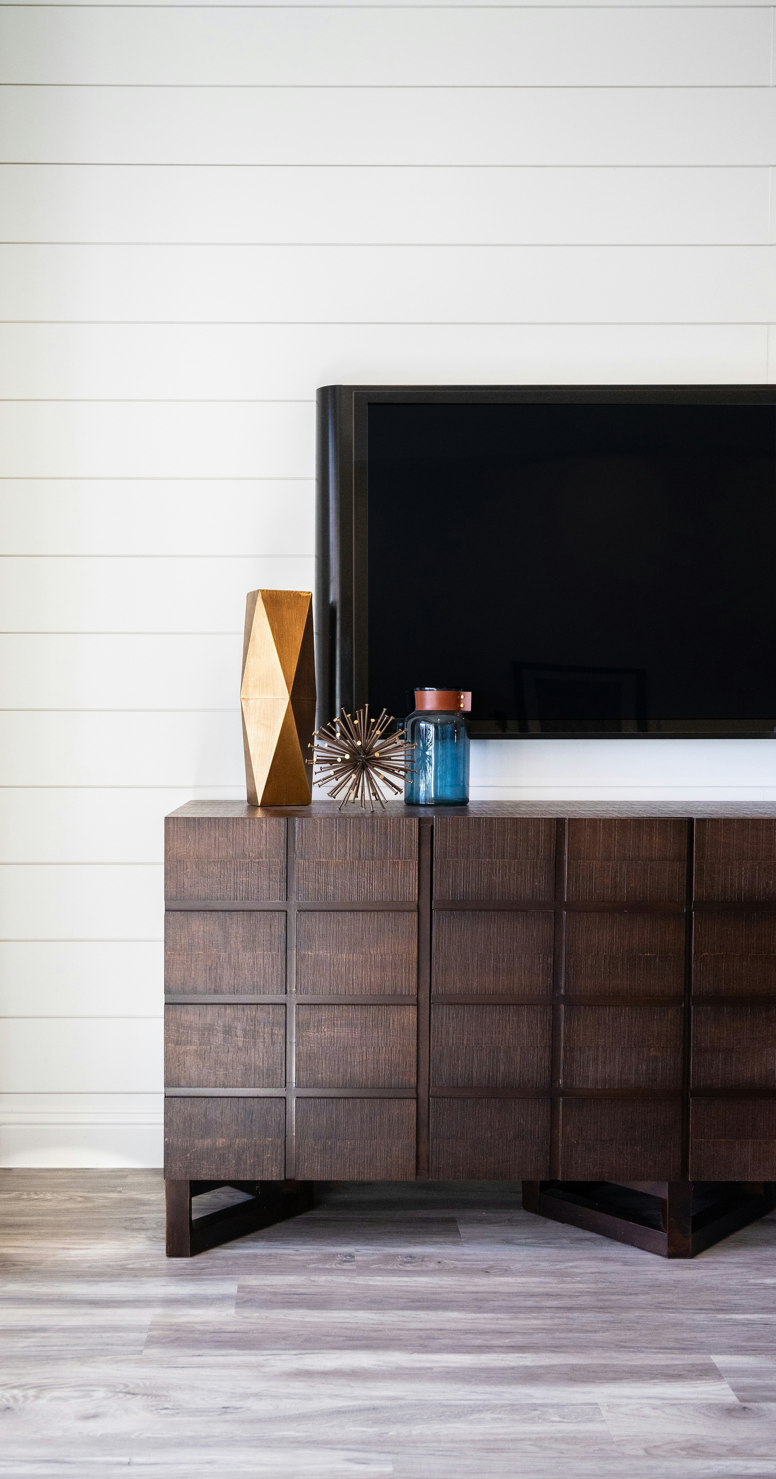 a wood cabinet with a tv and a wood cabinet with a glass top