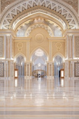 a large ornate room with a large ceiling and many arches