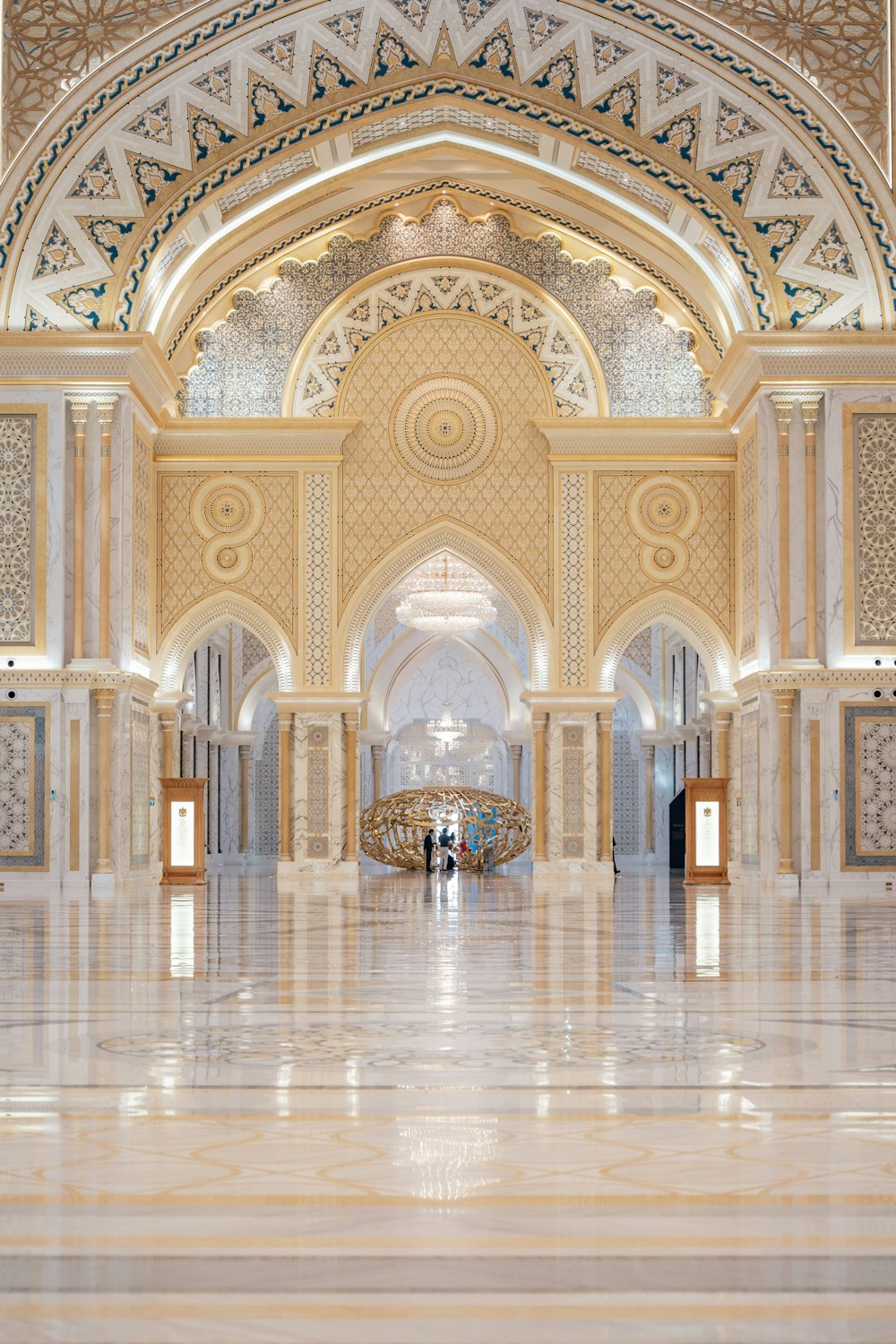 a large ornate room with a large ceiling and many arches