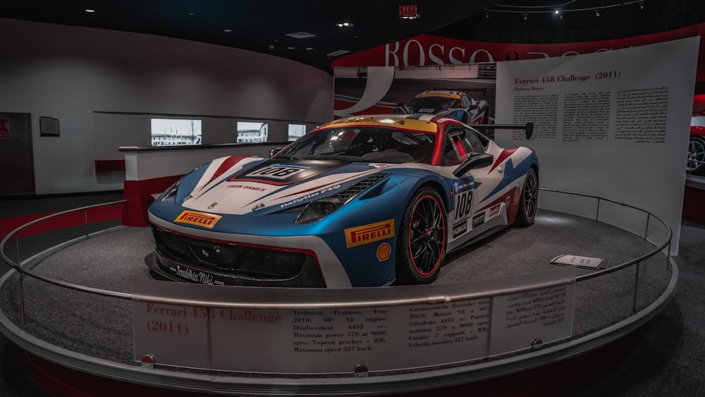 a blue and white sports car on a display