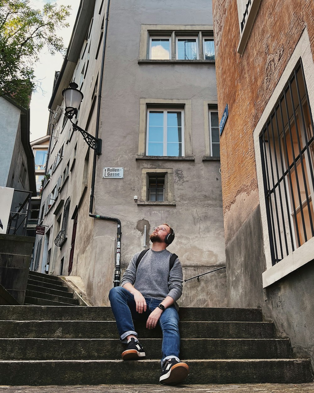 a man sitting on stairs outside a building