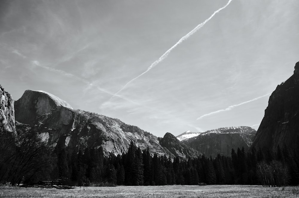 a mountain range with a trail of smoke