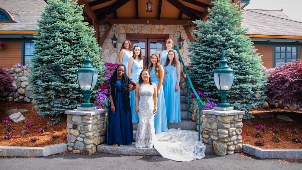 a group of women in dresses posing for a picture