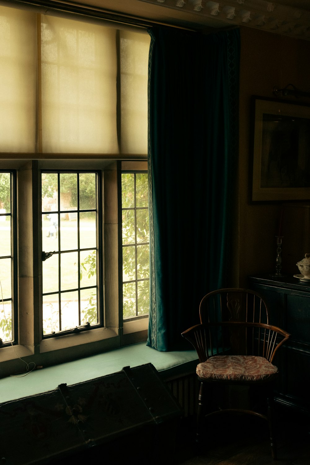 a room with a window and chairs