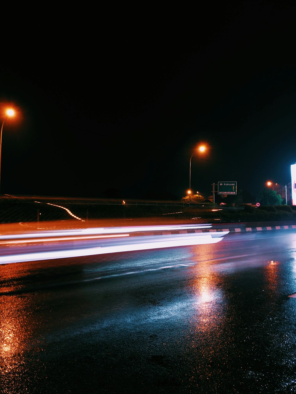 a car driving on a road at night