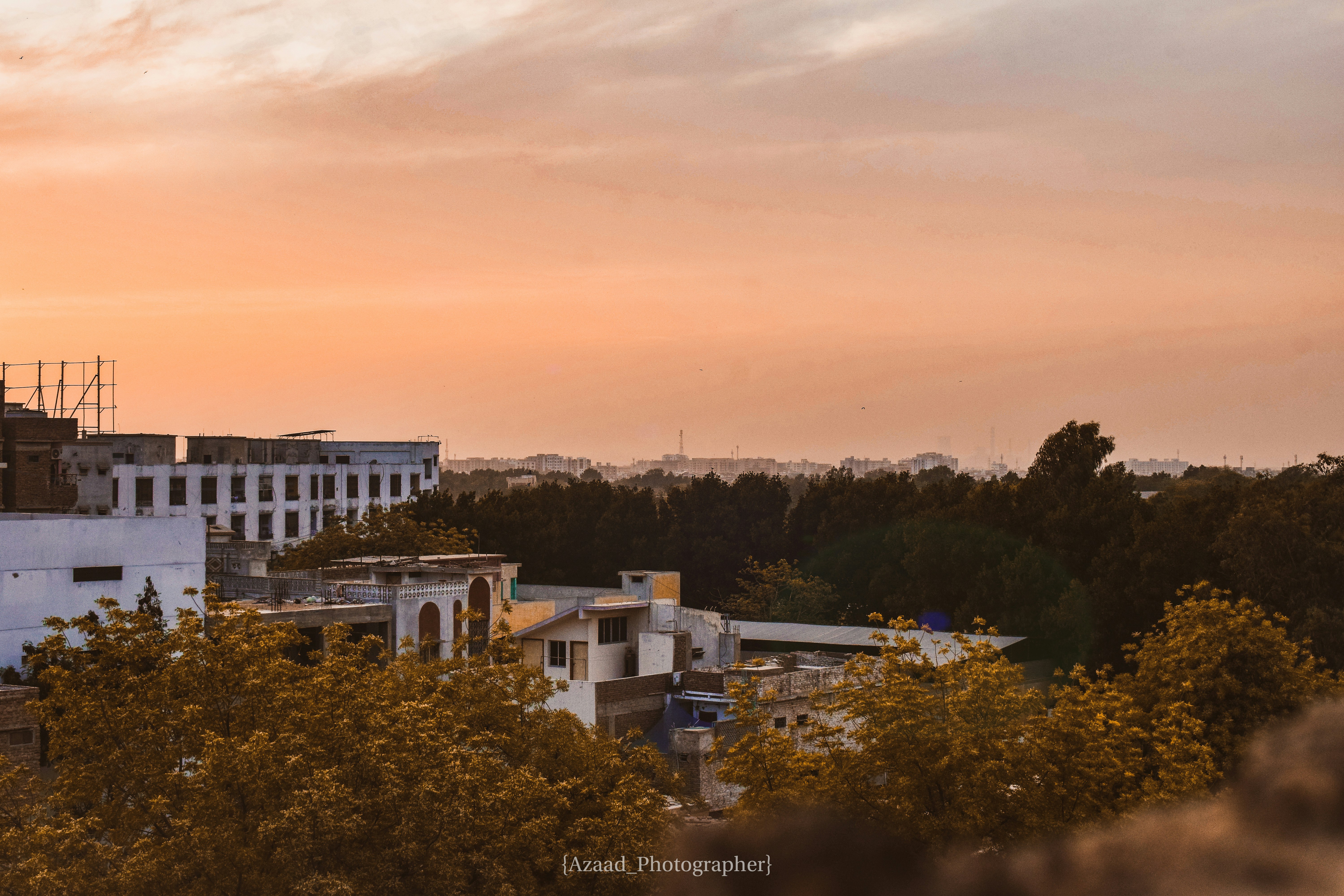 a group of buildings with trees in the front