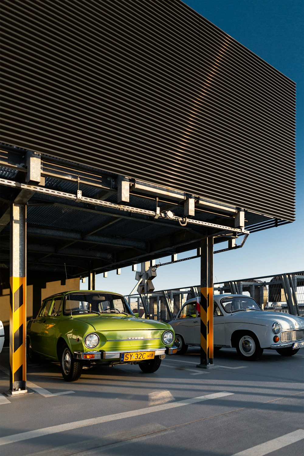 cars parked under a bridge