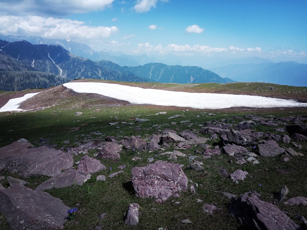 a rocky area with a body of water in the background