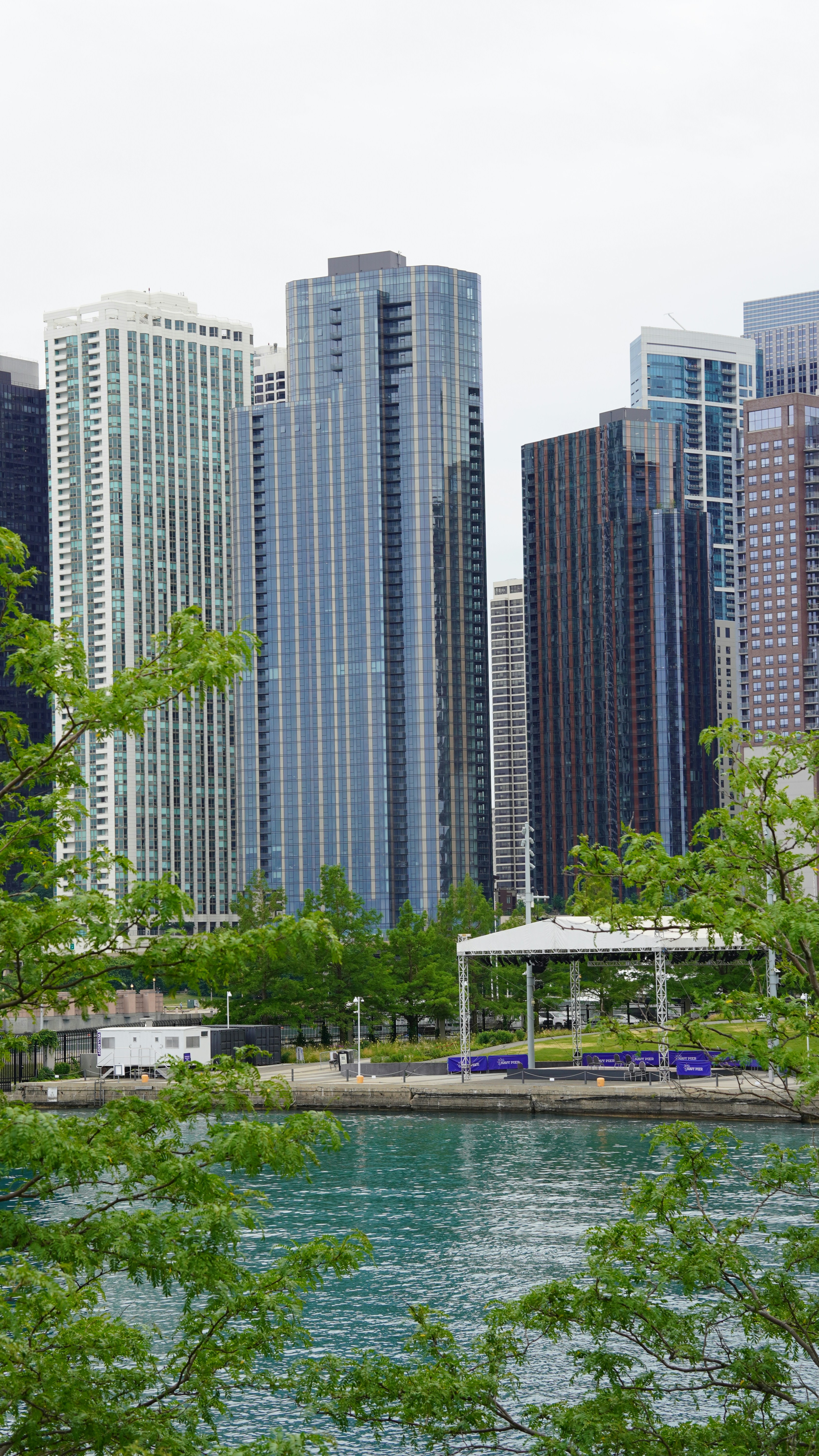 a body of water with trees and buildings around it