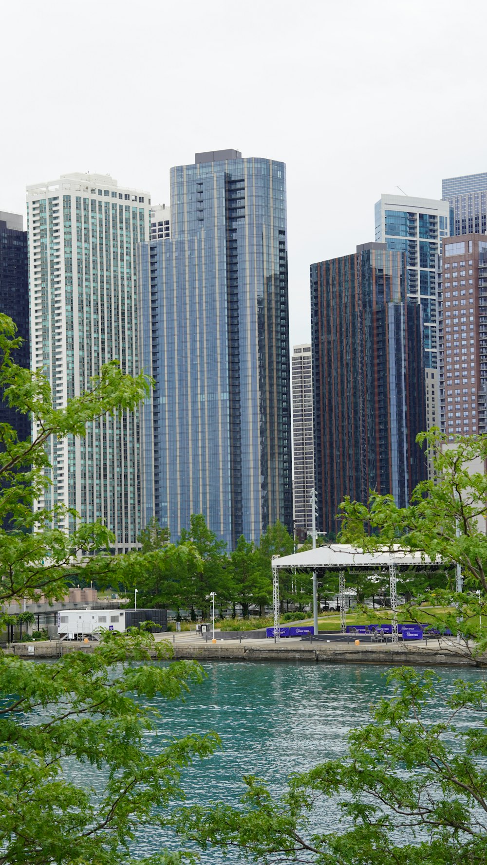 a body of water with trees and buildings around it