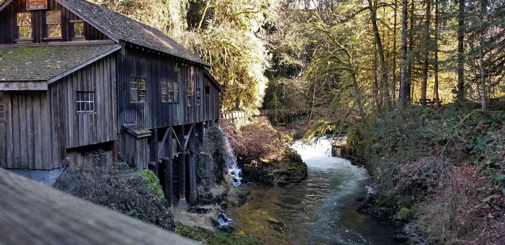 a cabin by a stream in the woods