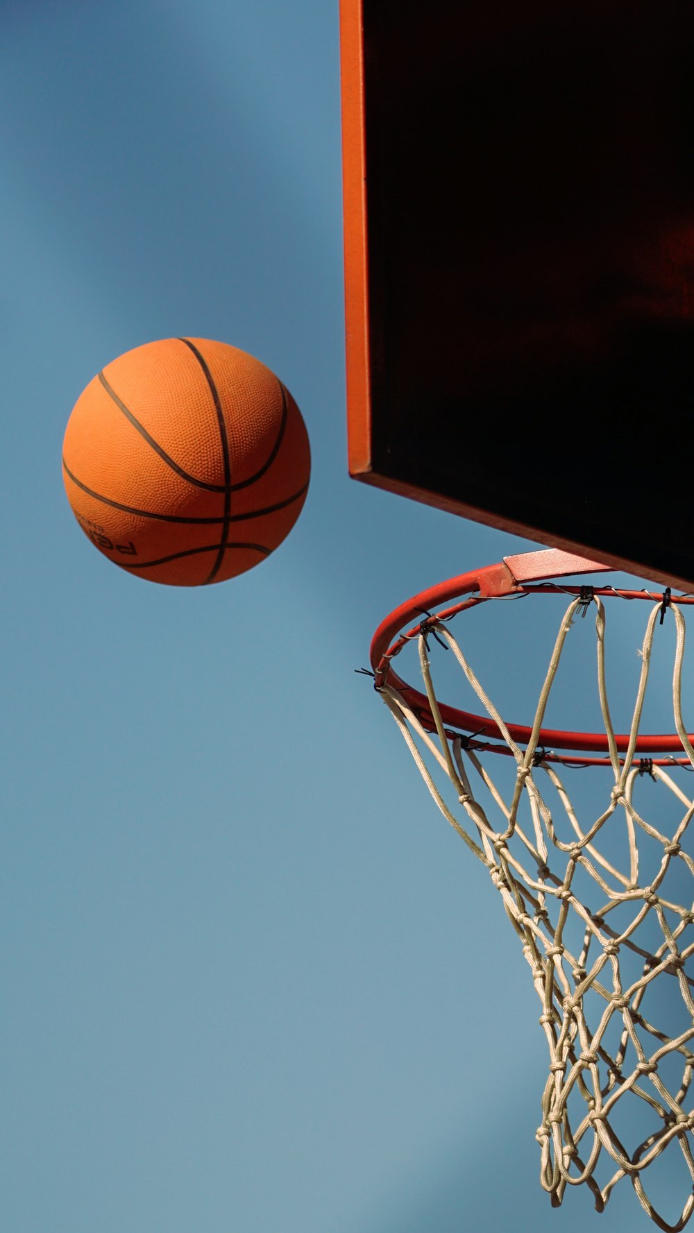 a basketball hoop with a ball in the air