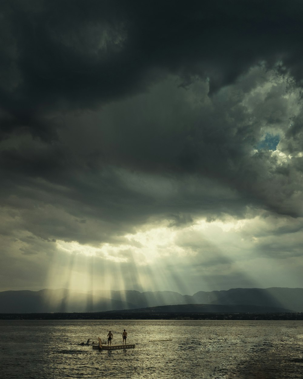 a group of people on a boat in the water with a lightning bolt in the background