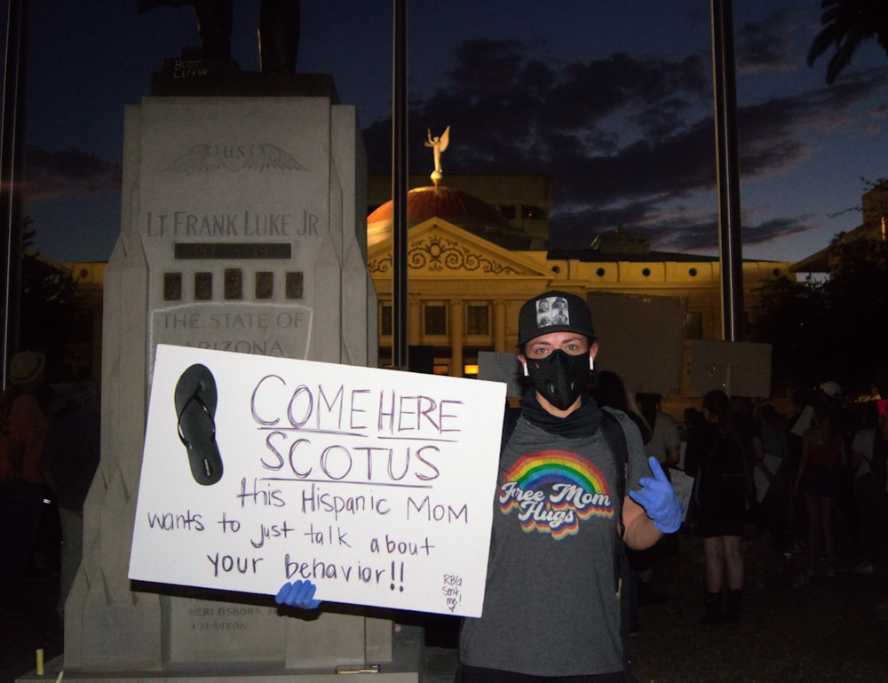 a person holding a sign