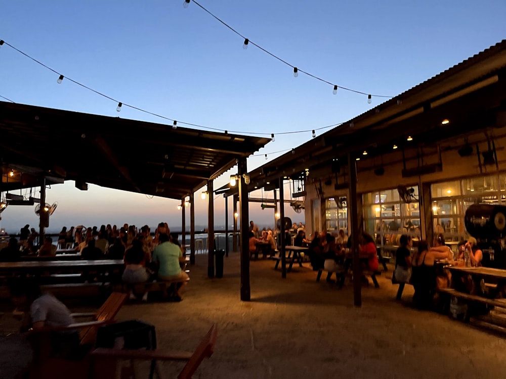 a group of people sitting outside a restaurant