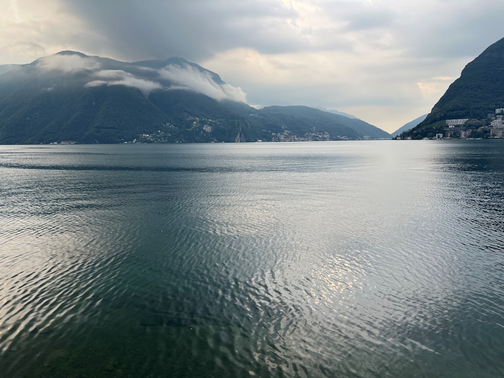 a body of water with mountains in the background