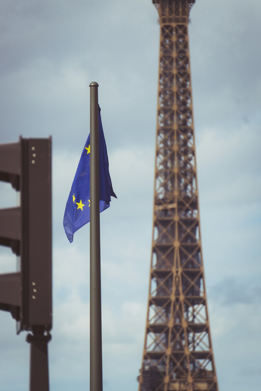 a tall metal tower with a flag