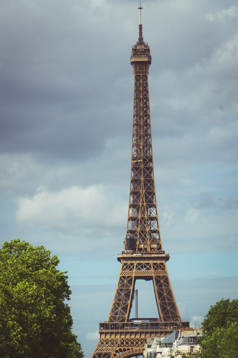 a tall metal tower with Eiffel Tower in the background