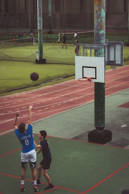 a group of people playing basketball