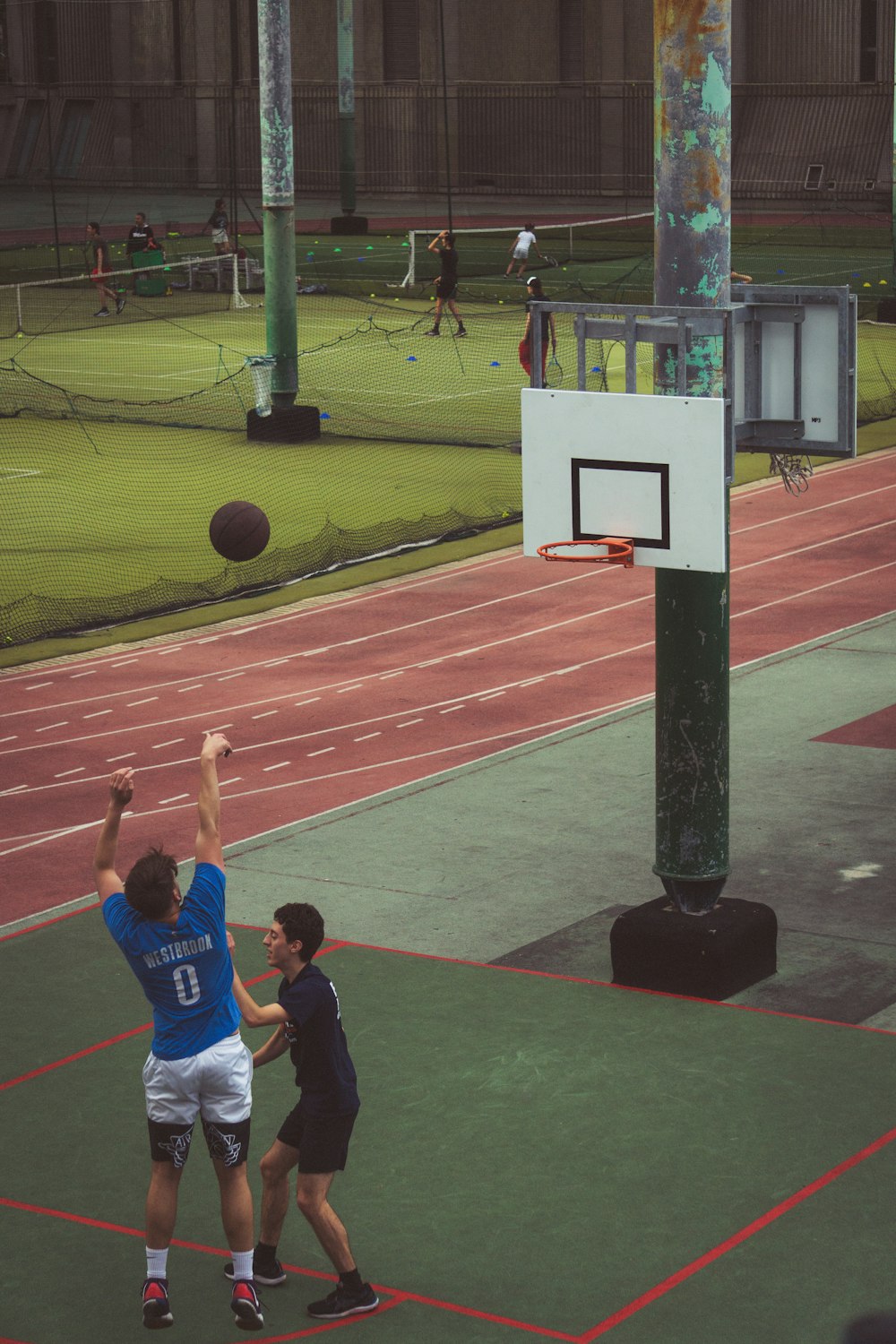 a group of people playing basketball