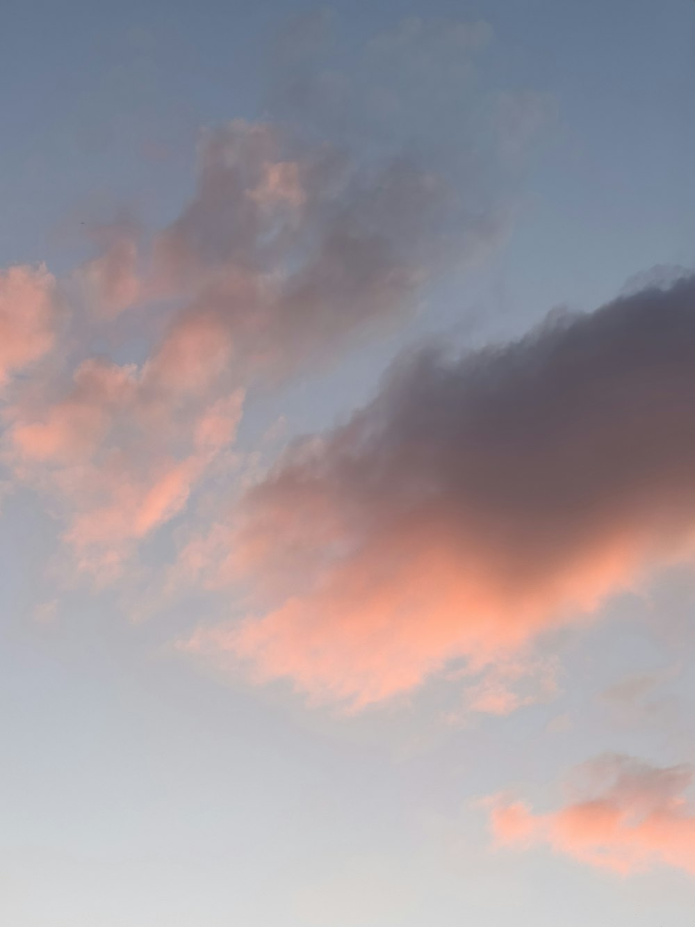 a pink and blue sky with clouds