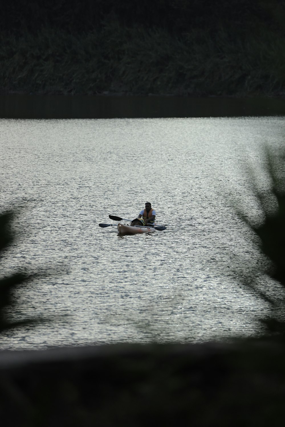 a couple people on a boat in a lake