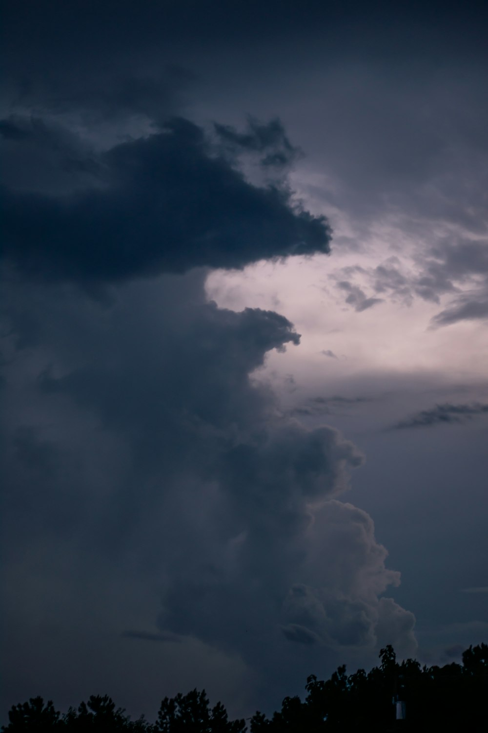 a cloudy sky with trees