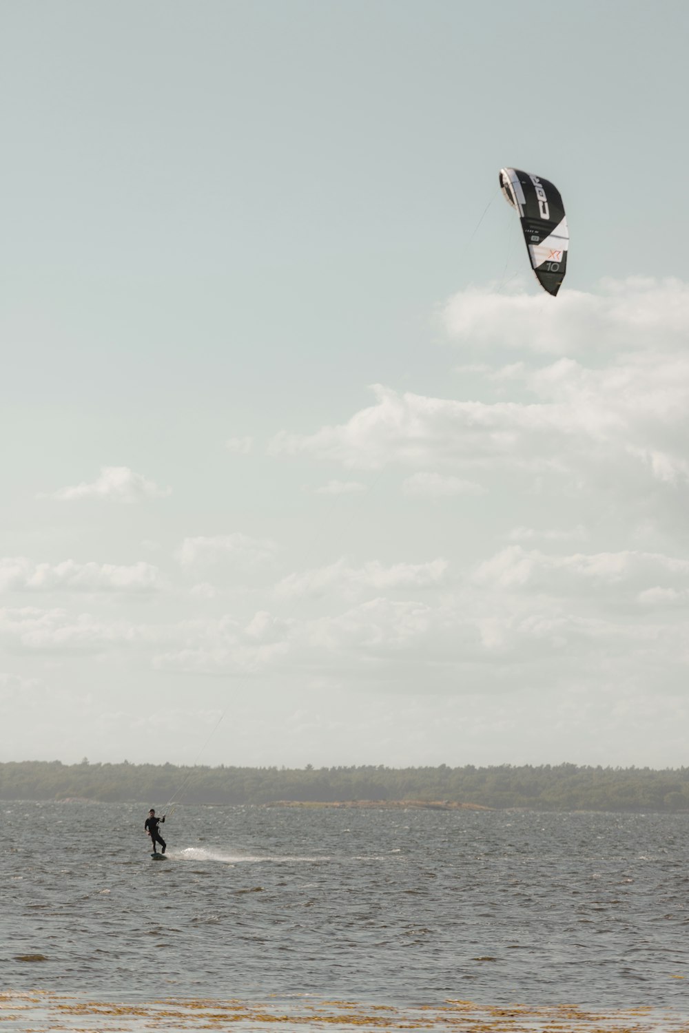 a person kite surfing on the sea