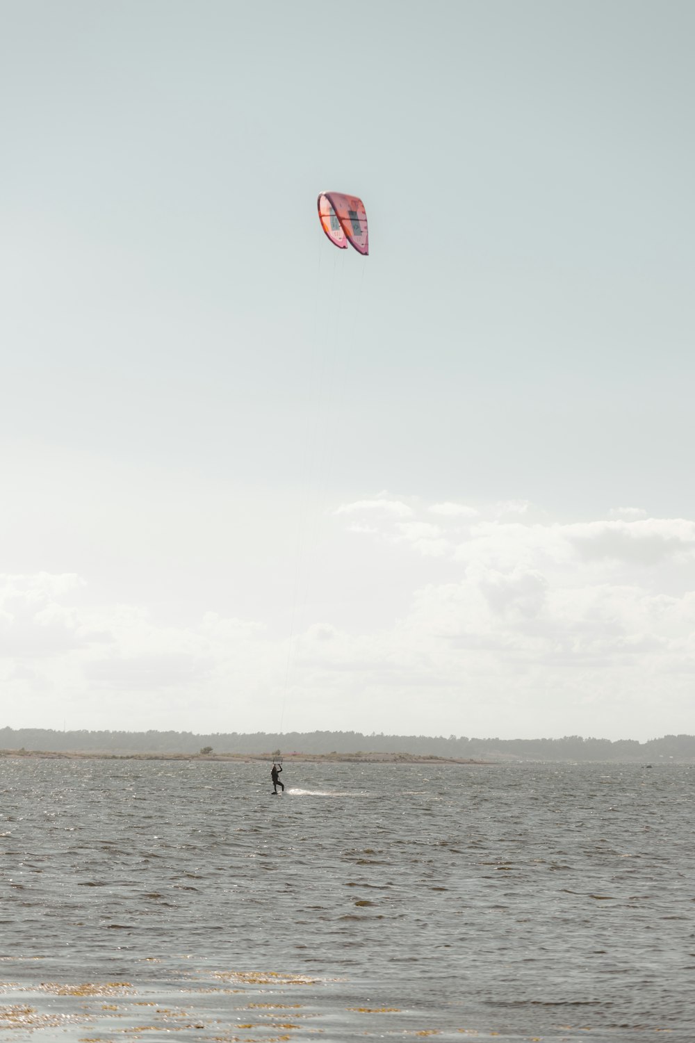 a person kite surfing in the sea