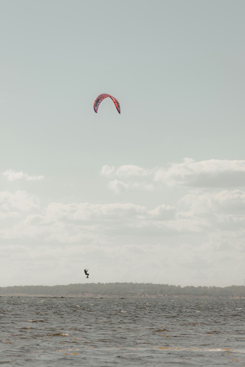 a person parasailing on the water