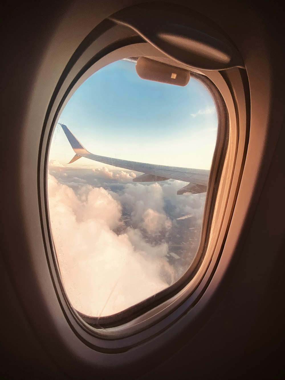 an airplane window with clouds